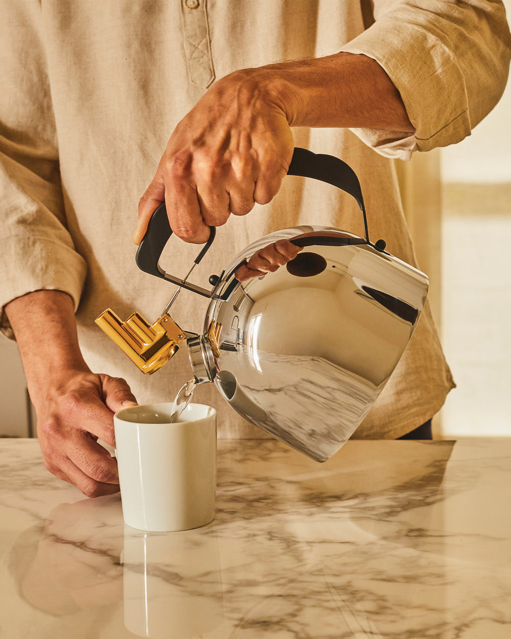 Alessi 9091 induction kettle designed by Richard Sapper. Dome shape in polished stainless steel, this stovetop kettle features a unique brass whistle. A truly unique compliment to tea time.