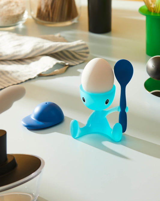 Alessi's quirky and fun Cico egg cup for kids and adults in various colours. With an arm holding the spoon and a matching hat, this little guy will bring smiles to breakfast time